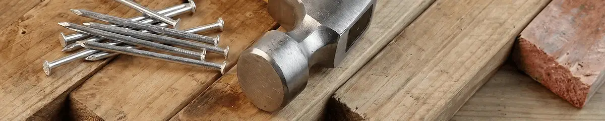 Hammer and nails on hardwood flooring boards in Henderson, NV